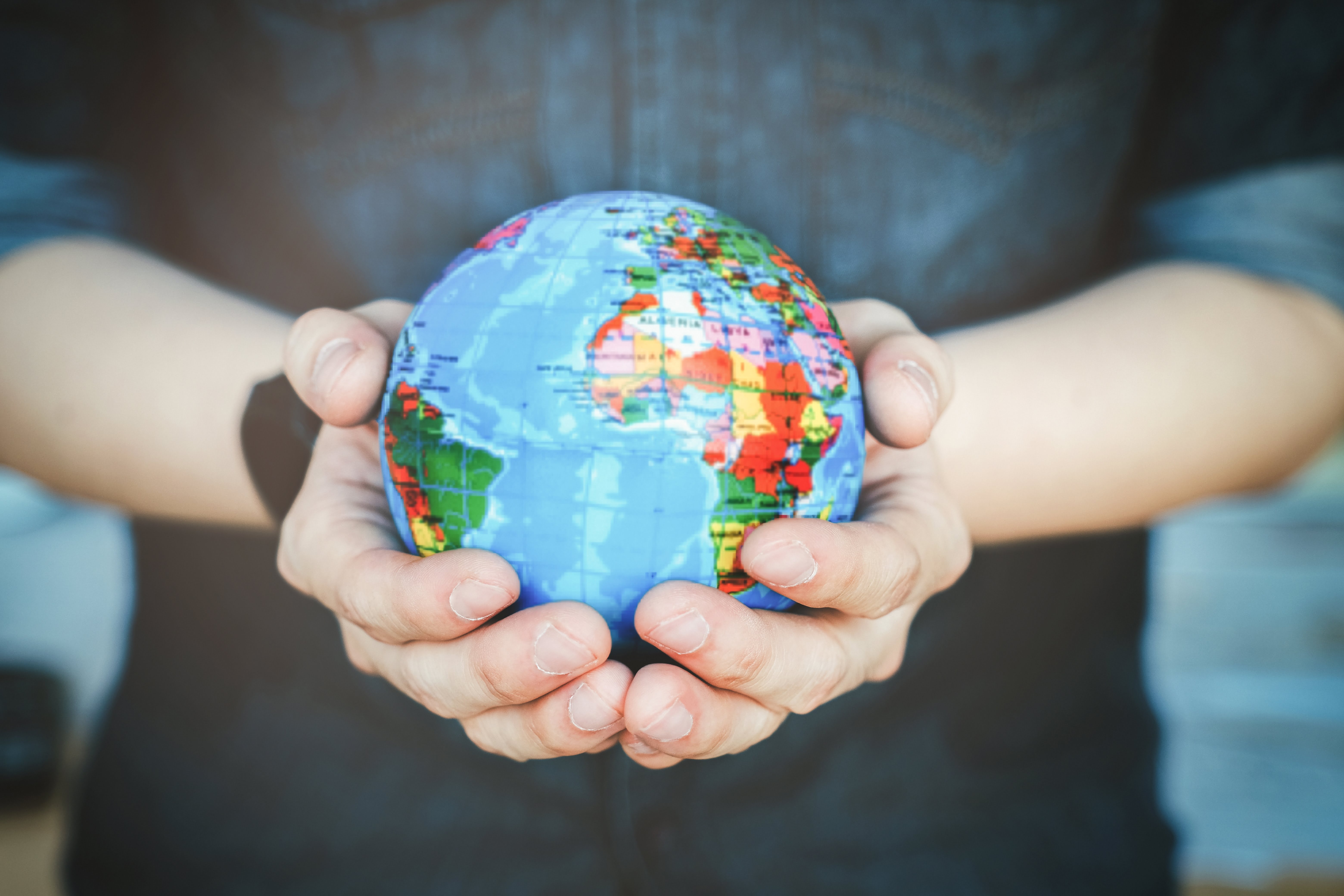 Hands holding globe